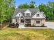 Front exterior view of a landscaped home with a well-manicured lawn, emphasizing its architectural design and curb appeal at 669 Balmoral St, Clayton, NC 27520