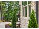 Exterior features beautiful landscaping, a stone wall, and large, bright windows at 669 Balmoral St, Clayton, NC 27520