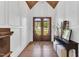 Inviting foyer with hardwood floors, wainscoting, a decorative table, and a view of the wood-framed front doors at 669 Balmoral St, Clayton, NC 27520