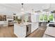 Open-concept kitchen island with seating, dining area views, and hardwood floors at 669 Balmoral St, Clayton, NC 27520