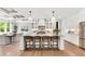 Kitchen island with a white countertop, pendant lights, and barstools, offering seating and style at 669 Balmoral St, Clayton, NC 27520