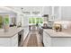 Bright kitchen island with white cabinetry, stainless appliances, and hardwood floors at 669 Balmoral St, Clayton, NC 27520
