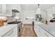 Modern kitchen with stainless steel appliances, white cabinets, and a stylish tile backsplash at 669 Balmoral St, Clayton, NC 27520