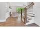 Bright living room featuring hardwood floors, a fireplace, built-in shelves, and large windows overlooking the backyard at 669 Balmoral St, Clayton, NC 27520