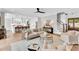 Bright living room with open floor plan, neutral decor, and access to the kitchen and stairway at 669 Balmoral St, Clayton, NC 27520