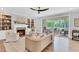 Cozy living room with a fireplace, built-in shelves, comfortable seating, and access to an outdoor screened in porch at 669 Balmoral St, Clayton, NC 27520