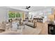 Open-concept living area with hardwood floors, comfortable seating, and a seamless flow to the kitchen and outdoor patio at 669 Balmoral St, Clayton, NC 27520