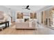 Inviting living room featuring hardwood floors, a fireplace, built-in shelving, and comfortable seating with natural light at 669 Balmoral St, Clayton, NC 27520