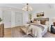 This bedroom has hardwood floors, a decorative chandelier and lots of natural light at 669 Balmoral St, Clayton, NC 27520