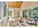 Spacious screened porch features vaulted wood ceilings, brick accents, and comfortable seating at 669 Balmoral St, Clayton, NC 27520
