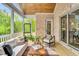 Relaxing screened porch featuring wood ceiling, sliding glass doors, and comfortable seating at 669 Balmoral St, Clayton, NC 27520