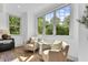 This sitting area has natural light, hardwood floors and 2 accent chairs overlooking the outdoor scenery at 669 Balmoral St, Clayton, NC 27520