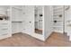 Well-organized walk-in closet with custom shelving, drawers, and hardwood floors at 669 Balmoral St, Clayton, NC 27520