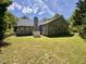 Lush backyard with mature trees, a fenced perimeter, offering privacy and ample space for outdoor activities at 6715 St Johns Ct, Raleigh, NC 27616