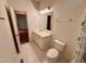 Bright bathroom features a single sink vanity, toilet and shower with neutral wall paint at 6715 St Johns Ct, Raleigh, NC 27616
