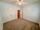 This bedroom features carpeted floors, a ceiling fan and a closet for storage at 6715 St Johns Ct, Raleigh, NC 27616