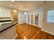 Bright dining area featuring french doors, hardwood floors, and modern lighting at 6715 St Johns Ct, Raleigh, NC 27616