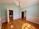 Bright dining room with hardwood floors and arched doorways at 6715 St Johns Ct, Raleigh, NC 27616