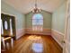 Elegant dining room with hardwood flooring, decorative chandelier, and abundant natural light at 6715 St Johns Ct, Raleigh, NC 27616