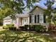 Well-maintained home featuring mature landscaping, an attached garage, and classic architectural details at 6715 St Johns Ct, Raleigh, NC 27616