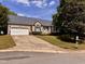 Inviting single-Gathering home featuring a spacious driveway, attached garage, and a well-kept lawn at 6715 St Johns Ct, Raleigh, NC 27616