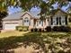 Charming single-story home with manicured lawn, attached garage, and inviting front entrance at 6715 St Johns Ct, Raleigh, NC 27616