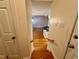 View down the stairs towards the kitchen from the hallway at 6715 St Johns Ct, Raleigh, NC 27616