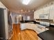 Well-lit kitchen featuring stainless steel refrigerator and modern appliances at 6715 St Johns Ct, Raleigh, NC 27616