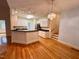 Bright eat-in kitchen featuring white cabinetry, a breakfast bar, hardwood floors and stainless steel appliances at 6715 St Johns Ct, Raleigh, NC 27616
