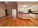Bright open-concept kitchen and living room featuring gleaming hardwood floors at 6715 St Johns Ct, Raleigh, NC 27616