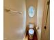Cozy powder room featuring a unique oval window at 6715 St Johns Ct, Raleigh, NC 27616