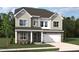 Charming two-story home boasts stone accents, gray siding, a two-car garage, and manicured landscaping at 708 Compeer Way # 27, Rolesville, NC 27571