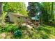 Secluded backyard offers serene setting with patio seating, lush landscaping and mature trees at 7313 Longstreet Dr, Raleigh, NC 27615