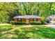 Charming brick home with green shrubs adding curb appeal at 7313 Longstreet Dr, Raleigh, NC 27615