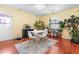 Eat-in kitchen with plants and a modern white table and chairs at 7313 Longstreet Dr, Raleigh, NC 27615