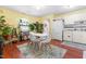 Eat-in kitchen filled with plants and a modern white table and chairs at 7313 Longstreet Dr, Raleigh, NC 27615