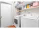 Bright laundry room features modern washer and dryer, white shelving, and ample storage space at 7313 Longstreet Dr, Raleigh, NC 27615