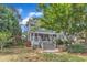 Lush backyard with patio, deck, mature trees, and well-manicured landscaping at 733 Hadrian Dr, Garner, NC 27529