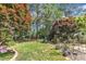 Beautiful backyard with mature trees, lush landscaping, and well-manicured lawn at 733 Hadrian Dr, Garner, NC 27529