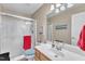 Clean bathroom with a glass-enclosed shower, white vanity, and neutral color scheme at 733 Hadrian Dr, Garner, NC 27529
