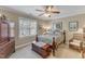 Comfortable bedroom featuring a bed with floral bedding, dark wood furniture, and a window view at 733 Hadrian Dr, Garner, NC 27529