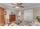 Relaxing bedroom featuring a plush quilt, dresser, closet, and a ceiling fan at 733 Hadrian Dr, Garner, NC 27529