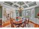 Elegant dining room showcases a wooden table, chandelier, and natural light with tranquil views of the yard at 733 Hadrian Dr, Garner, NC 27529