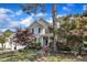 Two-story home features manicured front lawn with mature trees and charming front entry at 733 Hadrian Dr, Garner, NC 27529