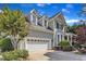 Charming home features manicured lawn, mature trees and an attached two-car garage at 733 Hadrian Dr, Garner, NC 27529