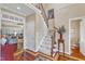 Welcoming foyer with hardwood floors, staircase, and elegant decor sets a tone of classic Southern elegance at 733 Hadrian Dr, Garner, NC 27529