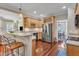 A kitchen featuring stainless steel appliances, granite counters, wood floors and a bar for seating at 733 Hadrian Dr, Garner, NC 27529