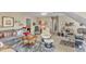 Comfortable living room featuring a sofa, chairs, a ceiling fan, and a work area at 733 Hadrian Dr, Garner, NC 27529