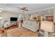Inviting living room boasts open layout, wood floors, comfortable seating, and seamless flow to the kitchen at 733 Hadrian Dr, Garner, NC 27529