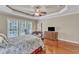 A primary bedroom boasts natural light, hardwood floors, and classic furnishings at 733 Hadrian Dr, Garner, NC 27529